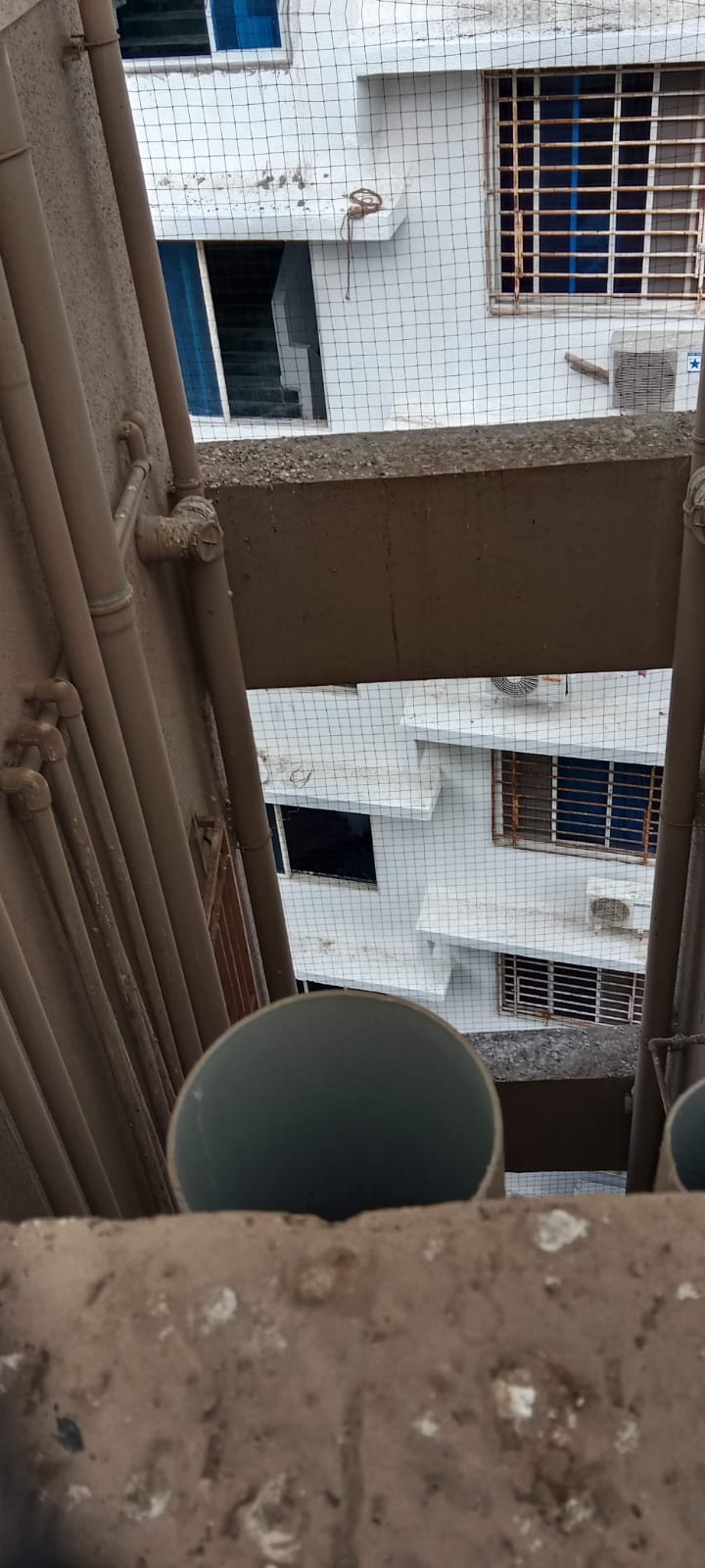 Fine mesh bird net stretched across a residential utility opening
